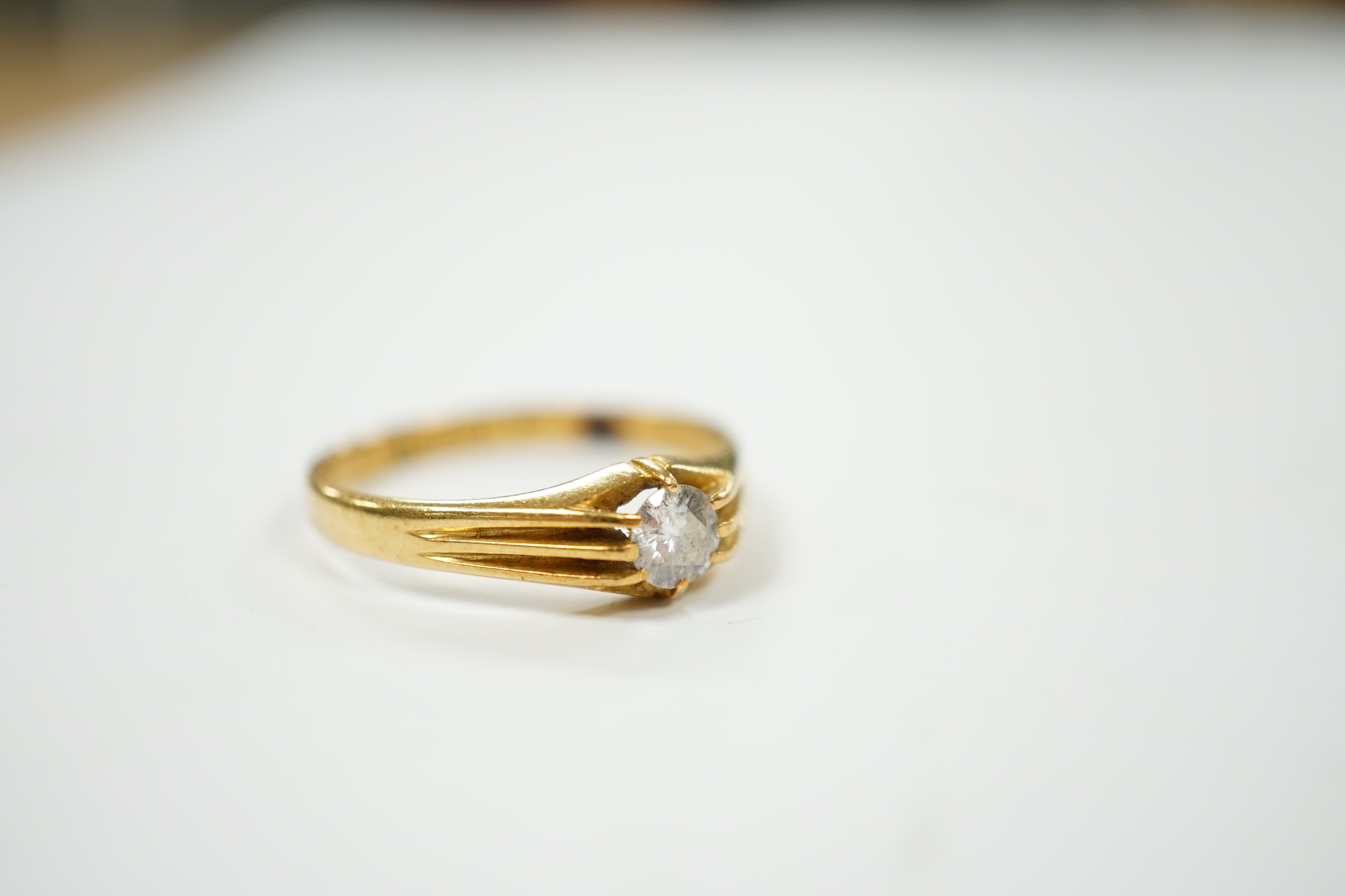A George V 18ct gold and claw set solitaire diamond ring, size U/V, gross weight 3.6 grams.
